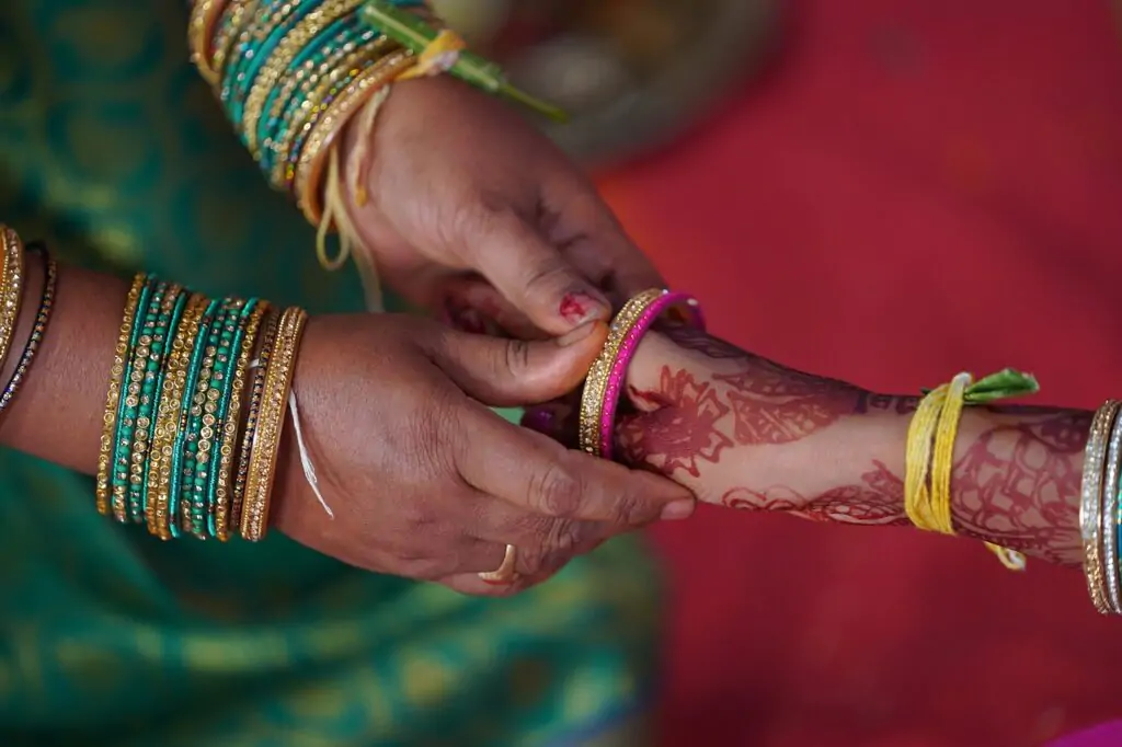 A Women holding her daughter hand and telling her marriage laws in Pakistan.